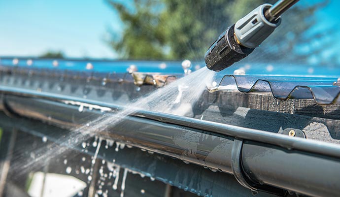 Cleaning gutter with pressure washer