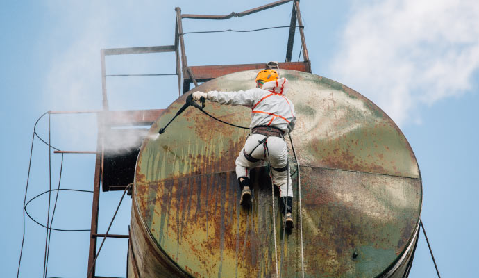 Cleaning industrial equipment using pressure wash