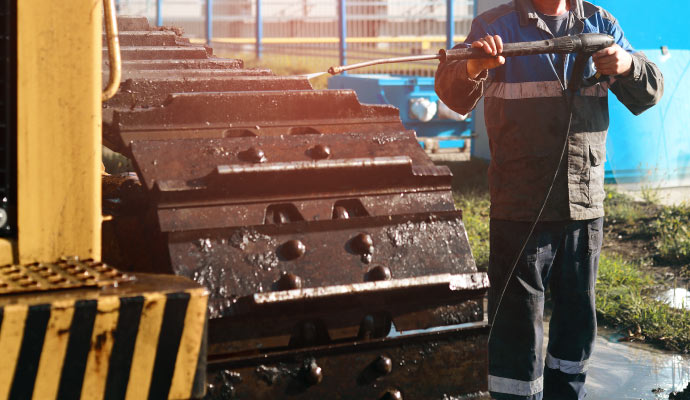 Pressure washing on heavy machinery
