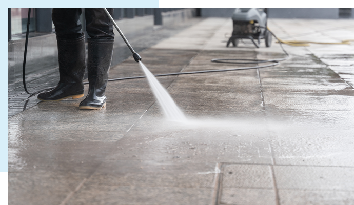 Cleaning parking lots with pressure washing services.