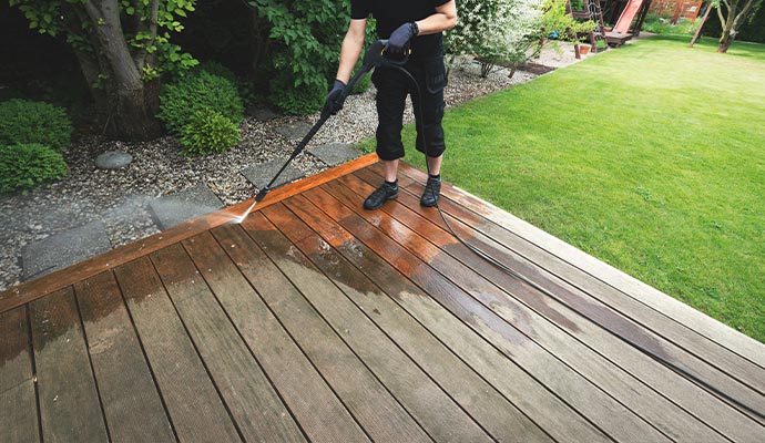 Deck stain cleaning performed by professional using power wash
