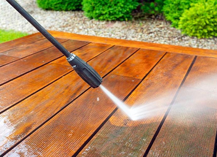 Professional pressure washing service for cleaning wooden deck