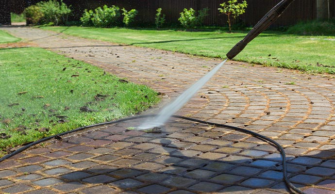 Professional cleaning street with high pressure washer