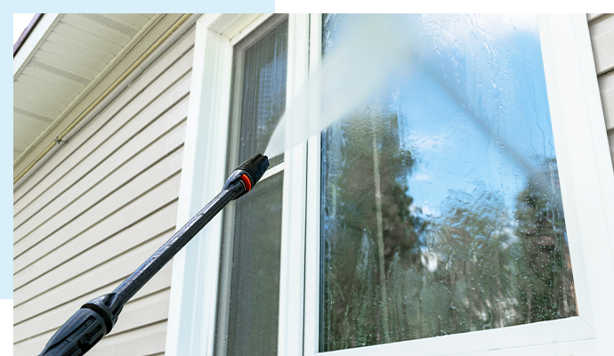 Expert window cleaner making windows clear and streak-free.